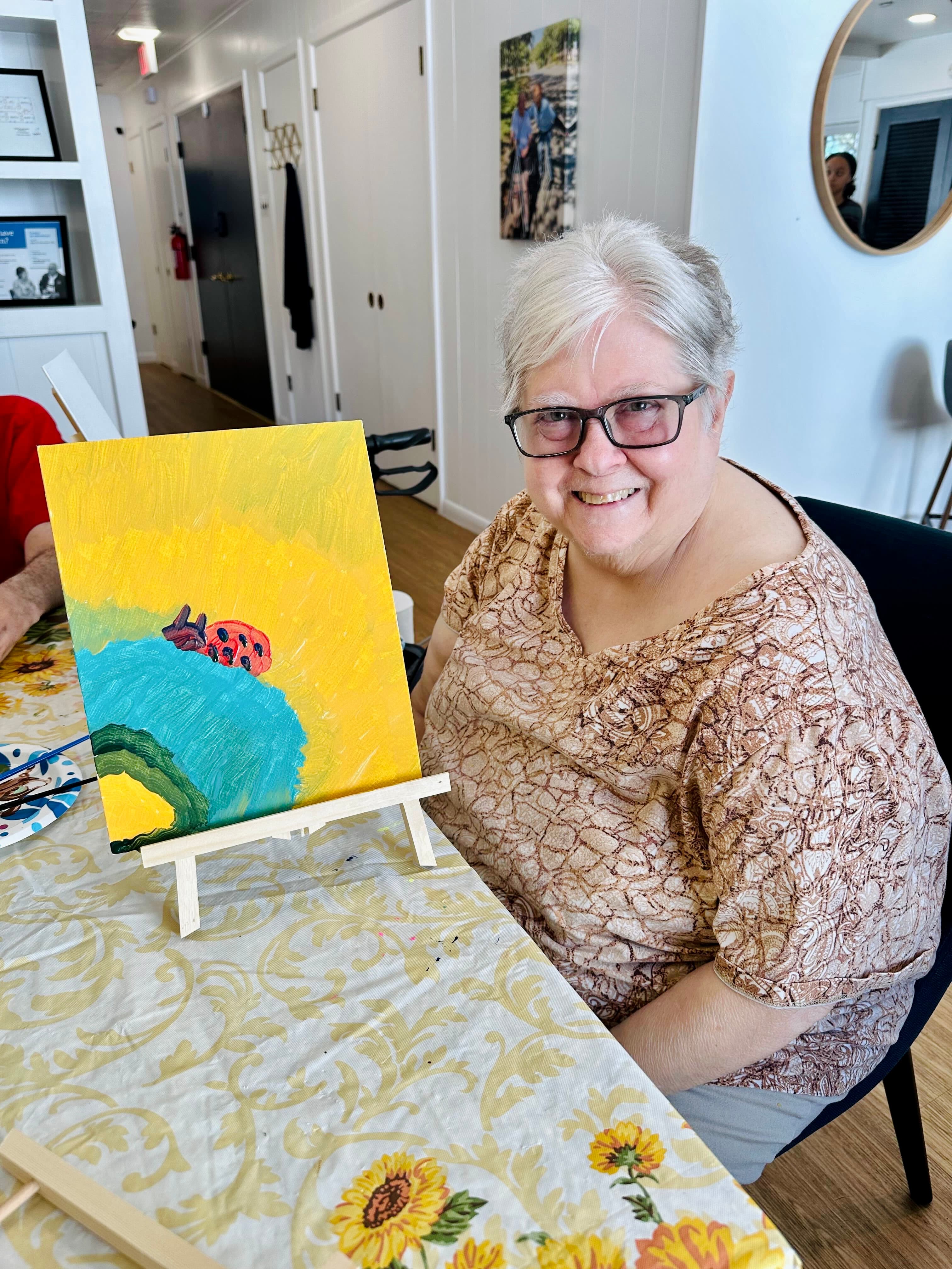 Resident showing her artwork at Timeless Care Homes